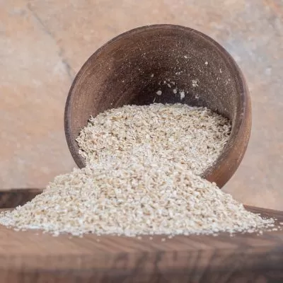 White rice in a wooden cup on the wooden platter. High quality photo